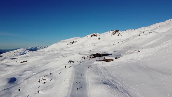 Aerial View of the Alps Mountains in France. Mountain Tops Covered in Snow. Alpine Ski Facilities