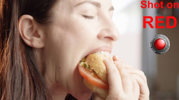 Beautiful Woman Eating Cheeseburger With Delight And Indulging With The Taste alt