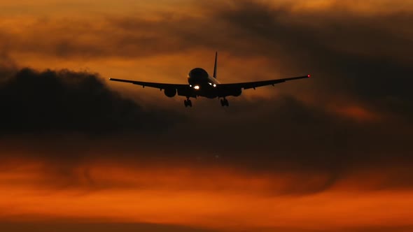 Airplane silhouette in the sunset sky