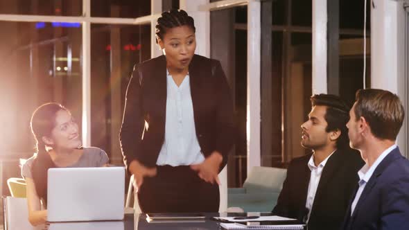 Businesswoman leading meeting in conference room alt