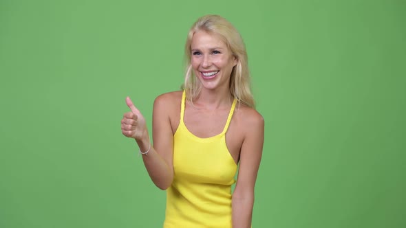 Young Happy Beautiful Blonde Woman Giving Thumbs Up