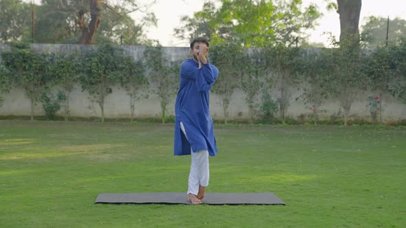 Indian man doing basic yoga pose alt