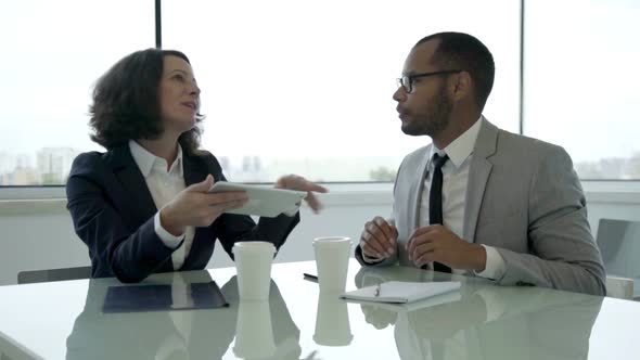 Slow Motion Shot of Two Colleagues Talking During Meeting alt