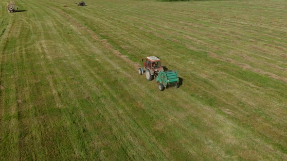 Agricultural Machinery Collects Dry Straw in Rolls and Round Large Bales