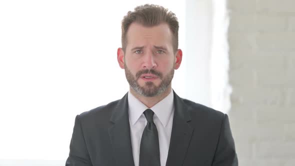 Middle Aged Businessman Looking at the Camera Sad Expression alt