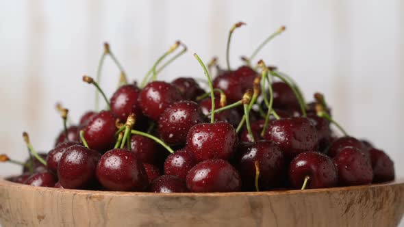 Fresh Ripe Juicy Cherries in a Wooden Bowl Rotation Zoom In Food Background