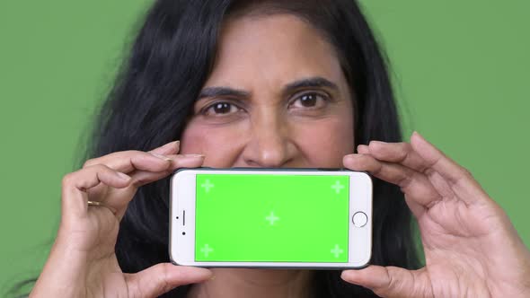 Close Up Shot of Mature Beautiful Indian Woman Showing Phone alt