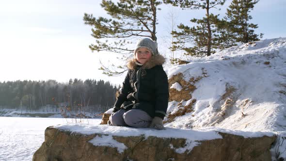 Young Girl Posing on Stony Cliff alt