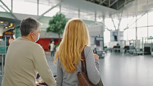 Back View Shot of Couple of Travellers Walking at Airport Building to Terminal Tracking Shot alt