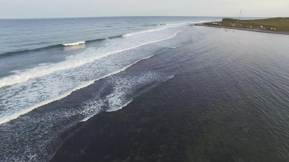 Drone View of Surfers Waiting for a Wave in the Sea at Sunset alt