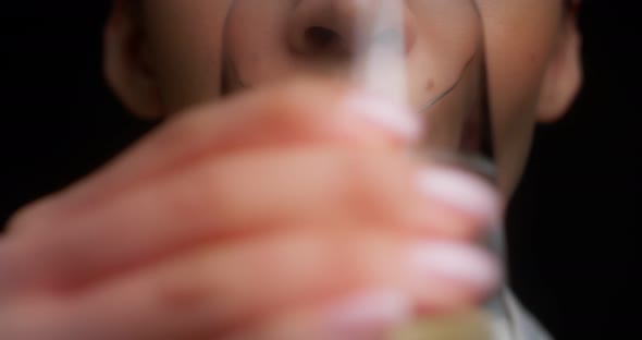 Closeup of the Lower Part of the Face of a Woman Drinking Water From a Glass