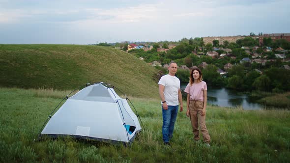 a Young Woman and a Man Communicate with Pleasure on the Mountain Hills Outdoor Recreation in the alt