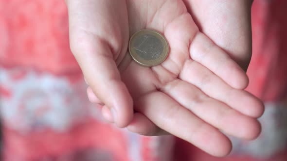 Coin is One Euro in Children's Hands
