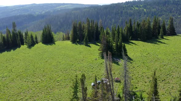 Orbiting aerial view of a camp site in the high Uinta Mountains with stunning scenery all around alt
