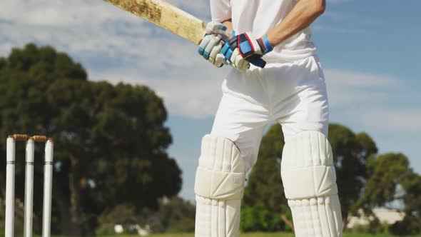 Cricket player shooting in the ball in a pitch alt