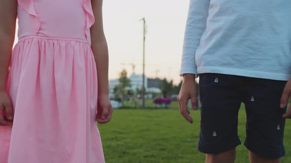 Boy and Girl Hold Hands Closeup alt