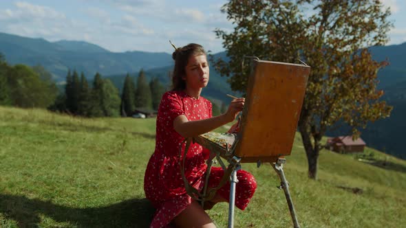 Talented Woman Drawing Easel on Green Meadow alt