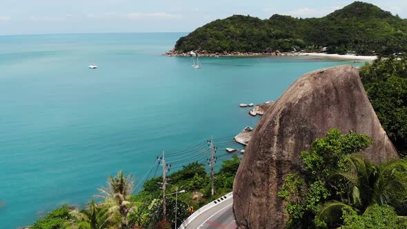 Main Road and Huge Stone on Seashore. Main Asphalt Road Going Near Large Elephant Rock on Tropical alt