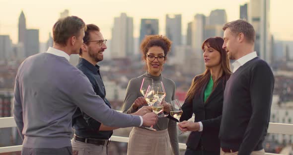 Group of business people toasting with wine after work