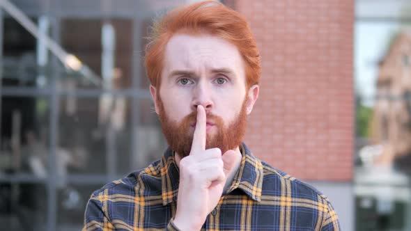 Silence Please Finger on Lips By Redhead Beard Young Man alt
