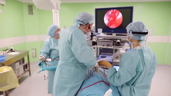 Neurosurgeon Is Cutting Brain Tumor in Head of Patient, Using Endoscopic Tools and Camera alt