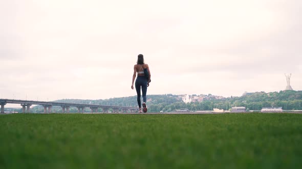 Girl with Fitness Mat on City Background