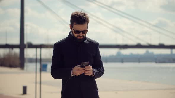 Businessman Talking On Phone. Businessman In Sunglasses Using Mobile Phone And Call. alt