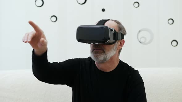 Adult Man Using Virtual Reality Glasses at Home Journey in the Metaverse alt