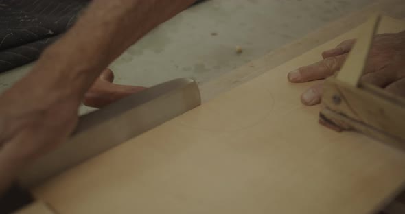 Luthier shaving wood