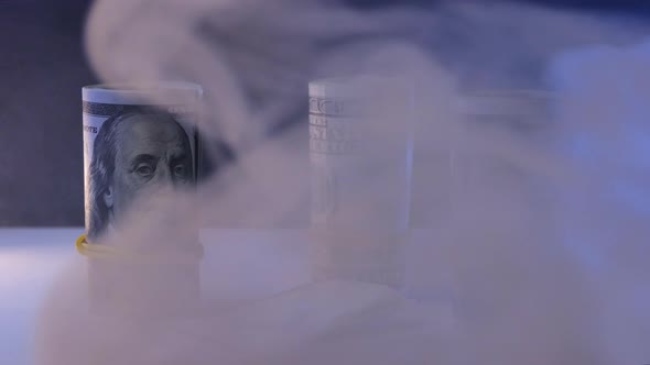 A Roll of Dollar Bills White Powder in a Transparent Bag alt