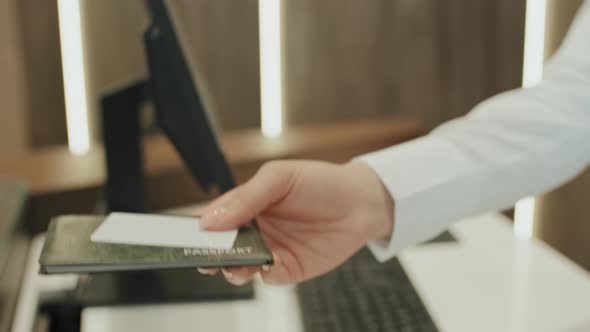 Giving Passport and Hotel Key Card to Customer alt