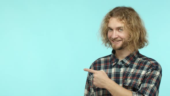 Slow Motion of Handsome Blond Man with Wavy Hair Pointing Finger Left and Nod in Approval Show