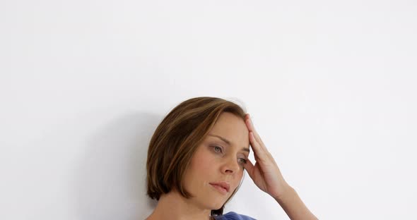 Woman holding her head alt