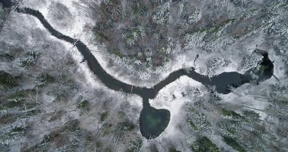 Heart Shape Sacred Spring Lake in Snowy Winter Forest Aerial Top View alt
