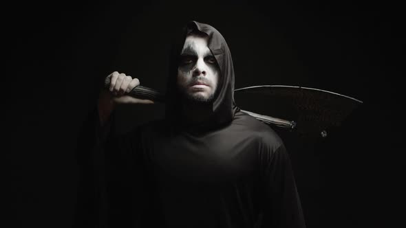 Grim Reaper Over Black Background with Axe in His Hands alt
