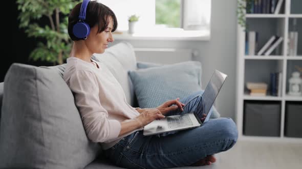 Woman with Laptop on Couch