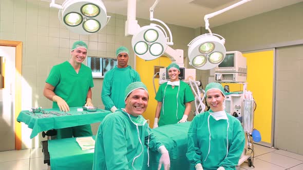 Several Surgeons surrounding an operation table alt