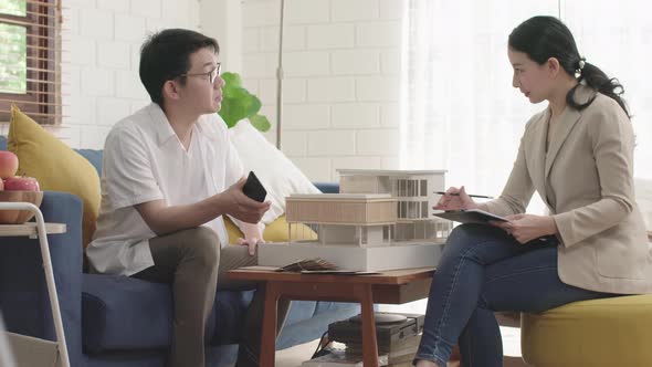home mortgage concept,smart asian female home agency present home new model to client asian male buy alt