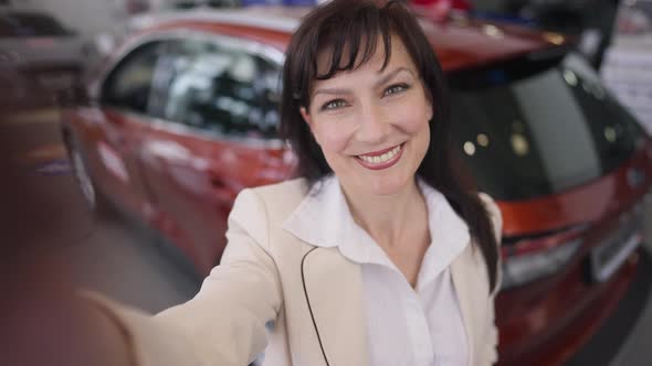 Selfie POV If Cheerful Beautiful Female Blogger Streaming Online From Car Dealership Choosing New alt
