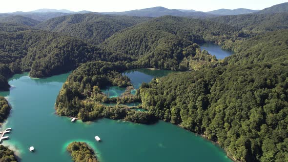 Flying over the famous Plitvice Lakes with forest at summer in Croatia, Europe alt