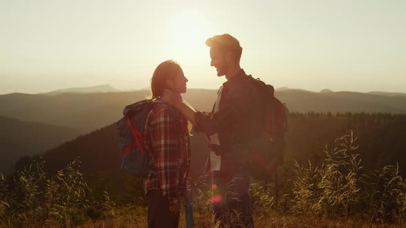 Loving Girl and Guy Spending Time Together in Mountains at Sunset alt