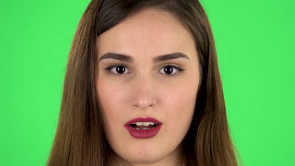 Beautiful Brunette Woman Looks at the Camera and Surprises. Close Up. Green Screen alt