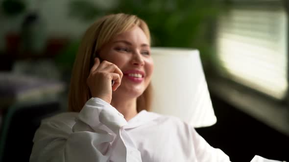 Happy Woman Is Chatting By Cell Phone with Friend, Resting at Home at Weekends alt