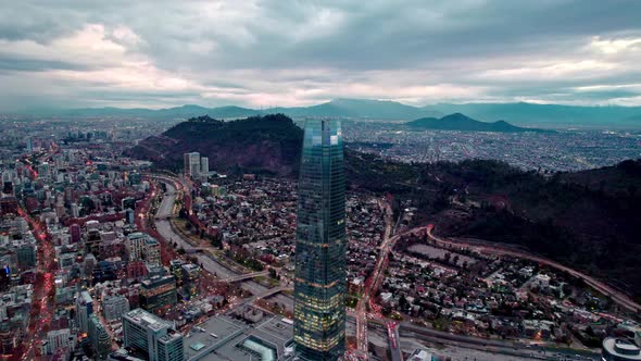 Pan right aerial view of the Costanera tower and the city of Santiago, Chile in the background, met alt