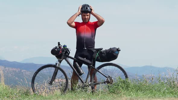 Cyclist Man Putting on Helmet alt