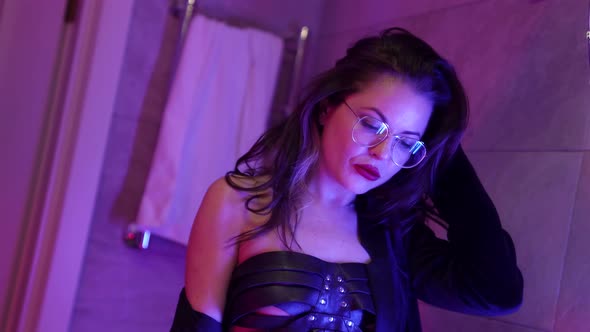 Portrait of a Sexy Brunette Woman in Glasses and a Black Suit She is in the Bathroom Standing in alt