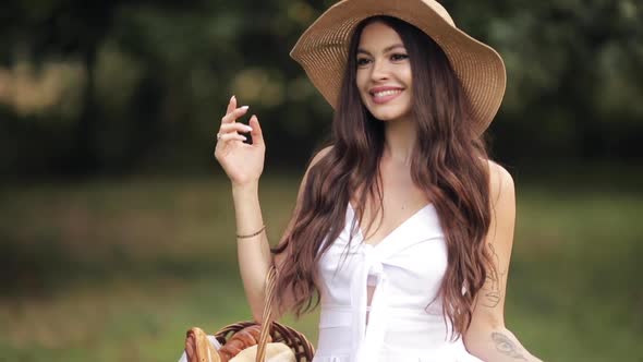 Beautiful Lady in a Straw Hat Sauntering in the Park