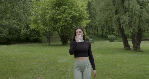 Sports Ladies After Training Walk in the Park and Drink Water alt