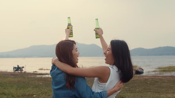 Group of Asia girl couple best friends teenagers drinking have fun salute toast of bottle beer.
