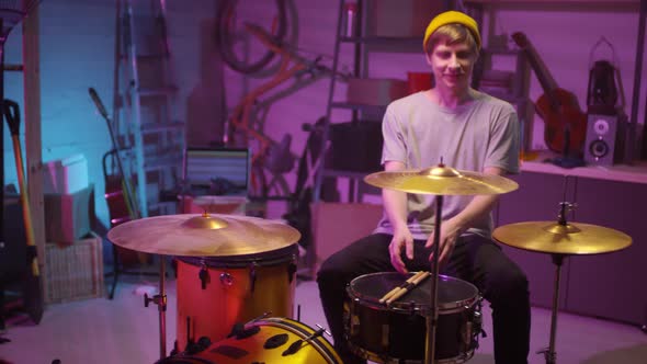 Cheerful Guy Starting Playing Drums alt